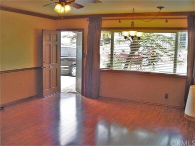 The living room is large with windows opening to t