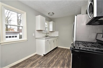 The beautiful kitchen has all new appliances, a lu