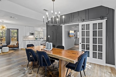 Dining area featuring a chandelier, light wood-st