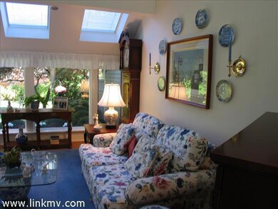 Bright spacious living room with 3 skylights