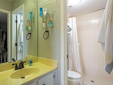Full bathroom featuring toilet, a stall shower, an