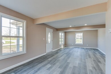 Fantastic living room with new paint, new laminate flooring, new windows & recessed lighting.