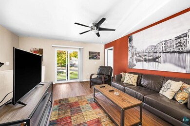 Living room featuring ceiling fan and hardwood / w