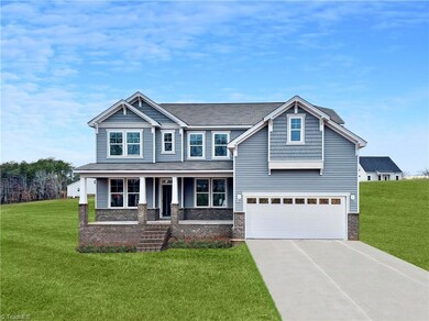 Front of home in construction. Photo enhancement of the home includes Grass and Driveway.