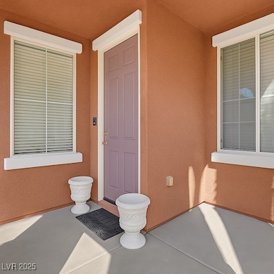Doorway to property featuring stucco siding