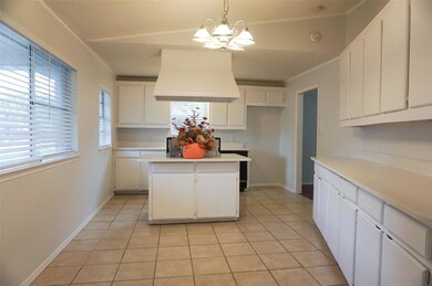 Kitchen featuring pendant lighting, island range h