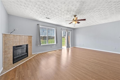 Unfurnished living room featuring visible vents, a