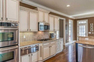 Another view of this kitchen - cooking outside?  Just a few steps out to your grill.  The views of the back patio and the beautifully landscaped back yard will make those hours in the kitchen so enjoyable and plus you can see your family or guests!