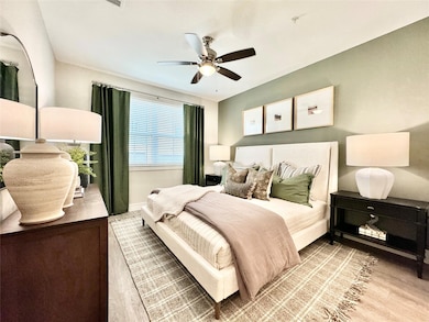 Bedroom featuring ceiling fan and light hardwood /