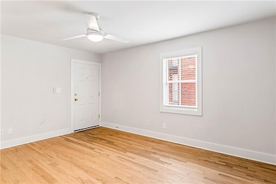 Spare room featuring light wood finished floors and ceiling fan