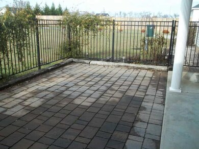 Covered patio with black aluminum fence