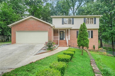 View of front of house featuring concrete driveway, a garage, and brick siding