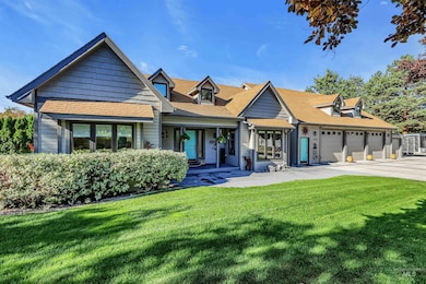 View of front of house with a front lawn, a shingled roof, covered porch, and driveway