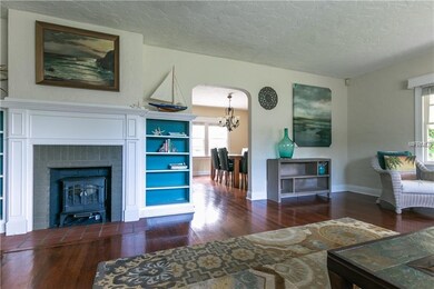 Living room with original wood floors and fireplac