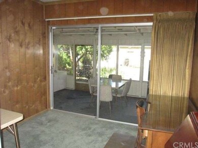 Den off the living room with sliding glass door op