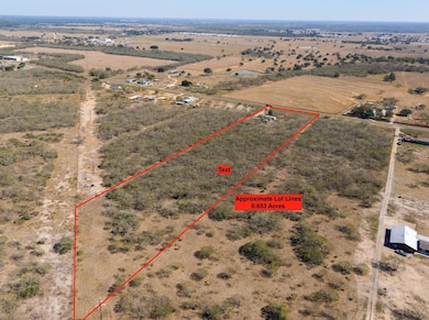 Aerial view of sparsely populated area with property parcel outlined