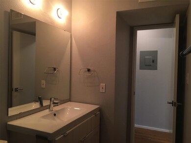 Bathroom with wood finished floors, vanity, elect