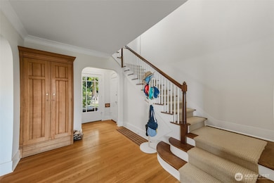 Unit B entry way with built in coat closet, new carpet on stairs.
