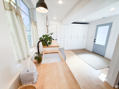 Foyer entrance featuring wood finished floors and recessed lighting
