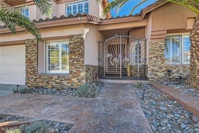 View of exterior entry with stone siding, stucco s