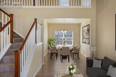 *virtually staged* Dining space featuring dark har