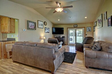 The living room has a ceiling fan, an access door