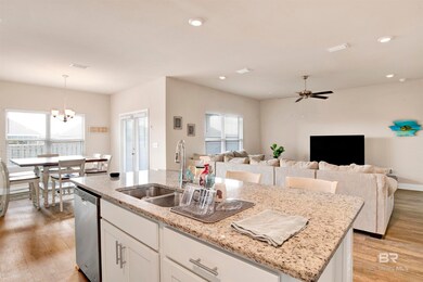 Kitchen featuring light hardwood / wood-style flooring, white cabinetry, an island with sink, and dishwasher