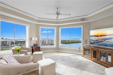 Living room featuring ceiling fan and crown moldin