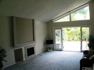 Living room with fireplace and cathedral ceilings