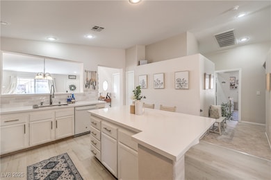 Kitchen featuring a sink, visible vents, backsplas