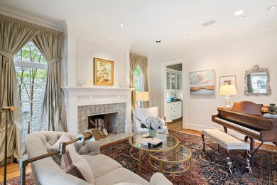 Living room with a tiled fireplace, hardwood / woo