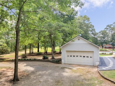 Detached garage with view of wooded area