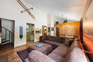 Living area with vaulted ceiling, spiral staircase