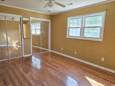 Unfurnished  master bedroom with multiple closets,