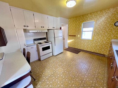 Kitchen featuring white cabinets and white applian