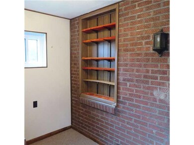 Family Room. Exposed Brick and built in shelves ad