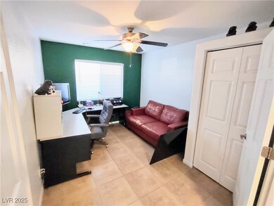 Office area featuring ceiling fan and light tile p