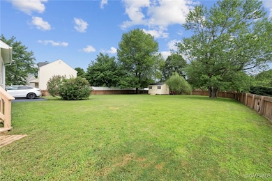 Fenced backyard with a storage unit