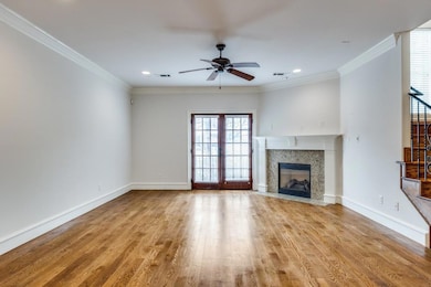 Unfurnished living room featuring ornamental moldi