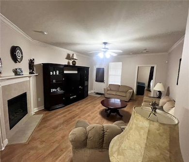 LIVING ROOM WITH CORNER WOOD BURNING FIREPLACE/MANTEL