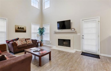 Living room featuring a premium fireplace, wood fi