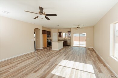 Living room featuring Plank floors, a ceiling fan,