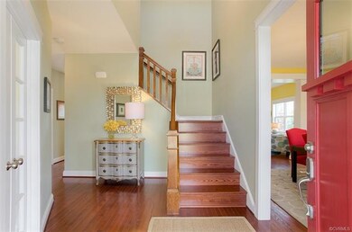 Vaulted Foyer with hardwood stairway
