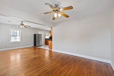 Unfurnished living room with light wood-style floors and ceiling fan