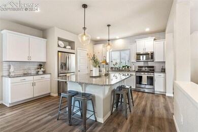 Kitchen featuring a kitchen island, dark hardwood 
