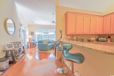 Kitchen with a breakfast bar, light hardwood / woo