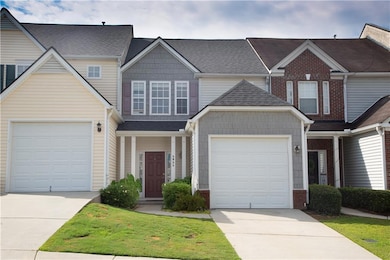 Traditional-style house featuring concrete driveway, a shingled roof, brick siding, and an attached garage