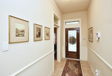 Step through the mahogany door with leaded glass insert into the foyer and you will immediately notice the beautiful woodwork and wainscot beadboard. Transom window above the cased door lets the natural light flow through. Tiled flooring and convenient storage closet round off this foyer.