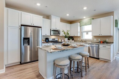 Stainless steel appliances and granite countertops. Image is of model, colors may vary.