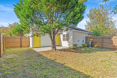 Back of house with central AC unit, a lawn, and a 